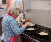 Cooking pancakes for Luncheon Club
